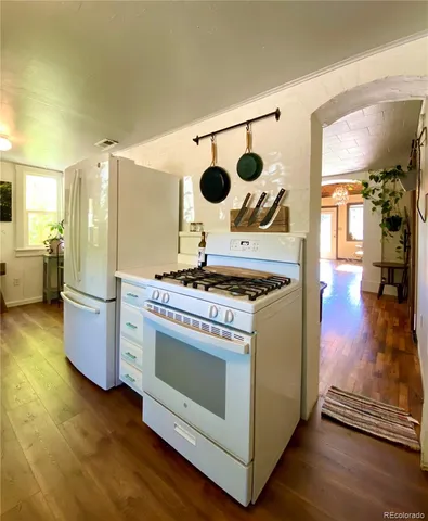 a kitchen with a stove and a white wooden cabinets