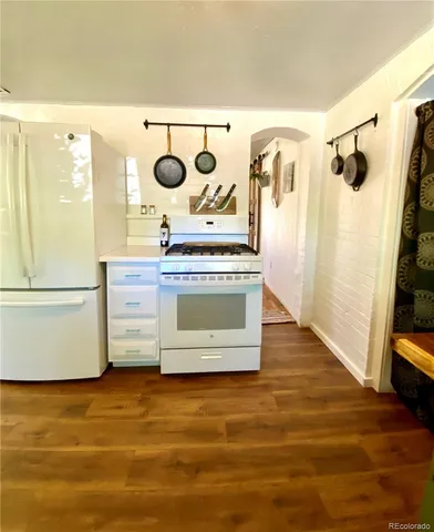 a view of a refrigerator in kitchen and wooden floor