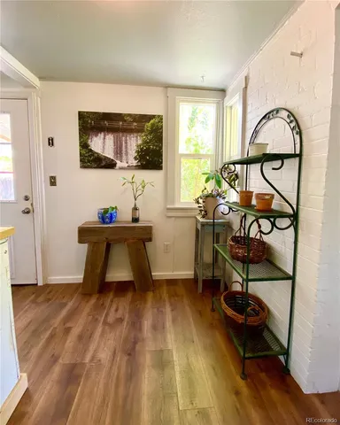 a living room with a bed furniture and a flat tv screen on the dresser