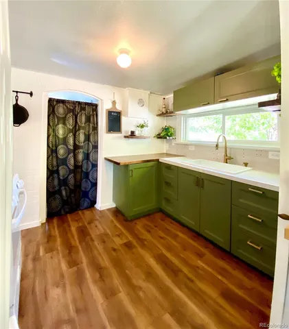 a kitchen with a sink window and cabinets