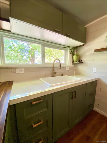 a kitchen with a sink and large window