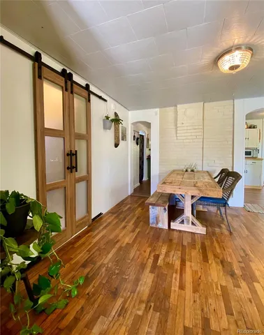 a bedroom with a bed and large windows