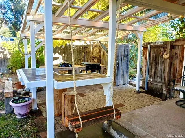 a outdoor space with the couches and large trees