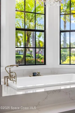 a view of a bathroom sink and a window