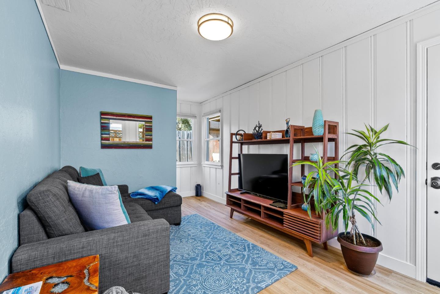320 Hillcrest Drive Aptos, CA 95003 - Photo 25 of 36 a living room with furniture a flat screen tv and a potted plant