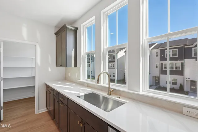 a picture of a room with a white wall and a large window