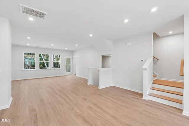 a kitchen with stainless steel appliances granite countertop a sink a stove and a wooden floors