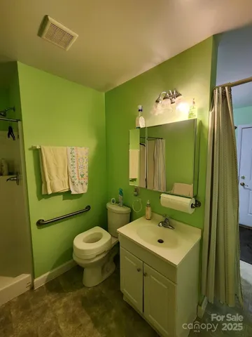 a bathroom with a sink toilet and mirror
