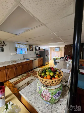 a kitchen with a stove and a wooden floor