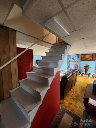 a view of gym equipment and stairs