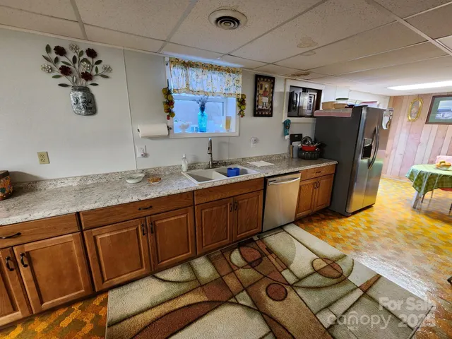 a kitchen with sink cabinets and refrigerator