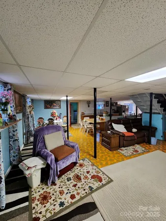 a living room with lots of furniture and wooden floor