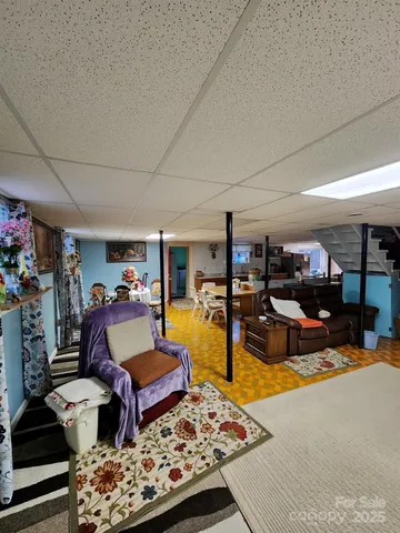 a living room with lots of furniture and wooden floor