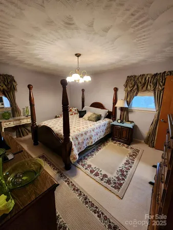 a bed room with two beds and a night stand