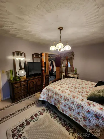 a bed room with a bed and a television