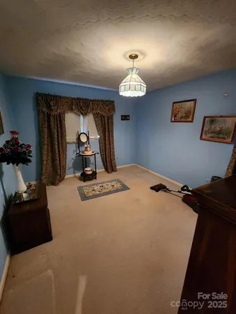 a bed room with a bed mirror and a window