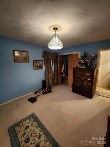 a bed room with a bed and a chandelier