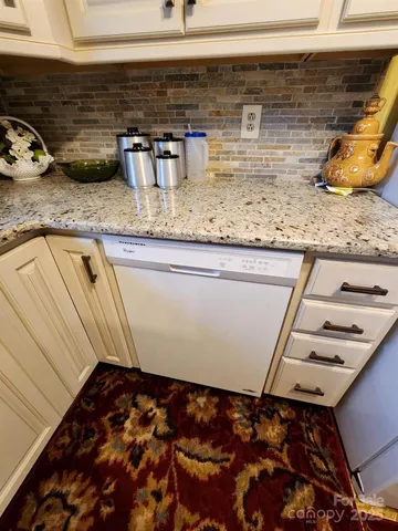 a white refrigerator freezer sitting inside of a kitchen