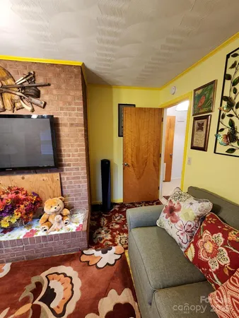 a living room with fireplace furniture and a flat screen tv