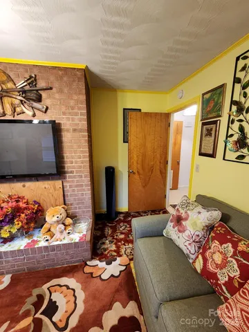 a living room with fireplace furniture and a flat screen tv