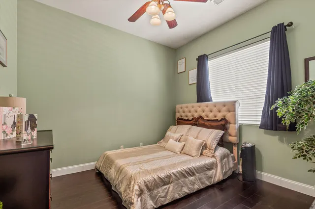 a bedroom with a bed and a potted plant