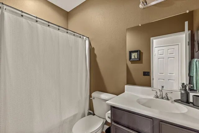 a bathroom with a sink toilet and mirror