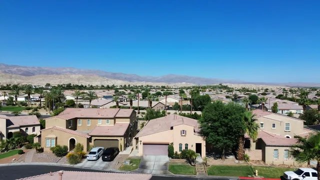an aerial view of residential houses with city view
