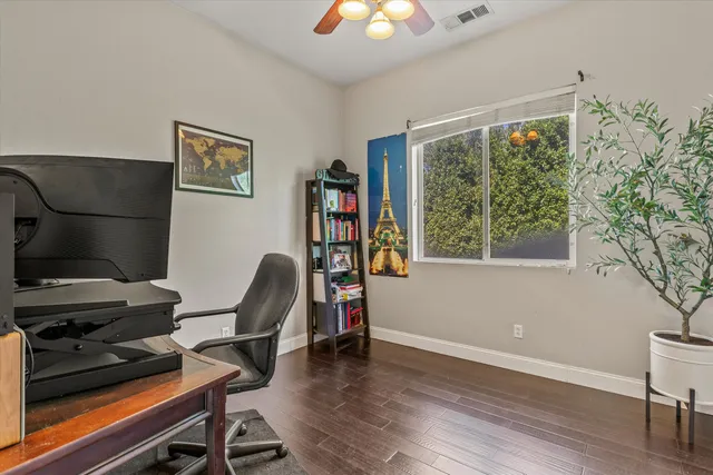 a view of a workspace with furniture and a window