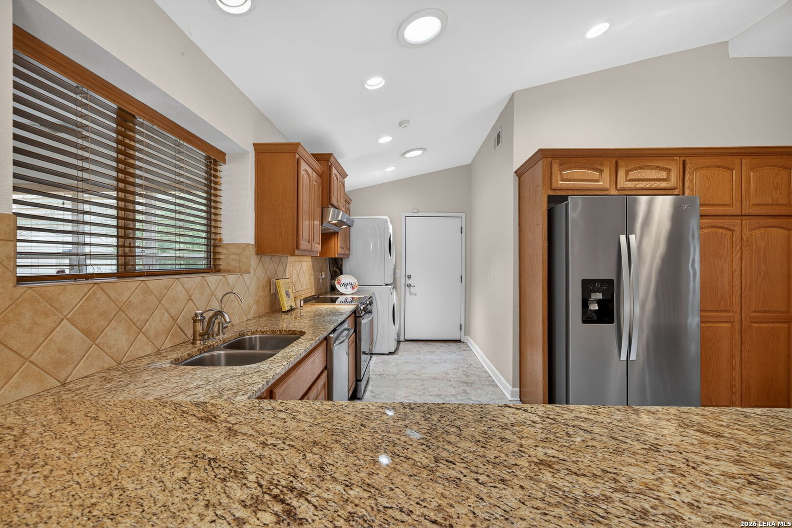 121 Fort Wayne Universal City, TX 78148 - Photo 13 of 34 a kitchen with refrigerator and window
