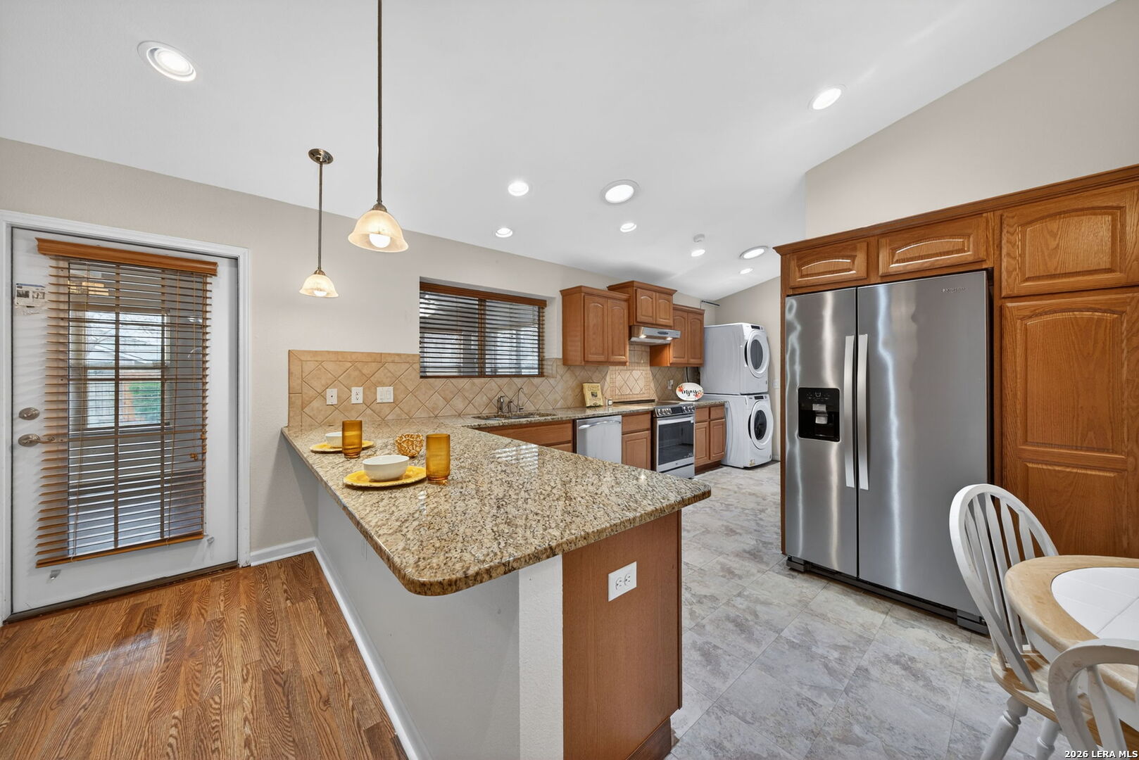 121 Fort Wayne Universal City, TX 78148 - Photo 14 of 34 a kitchen with stainless steel appliances granite countertop a refrigerator a sink and a stove