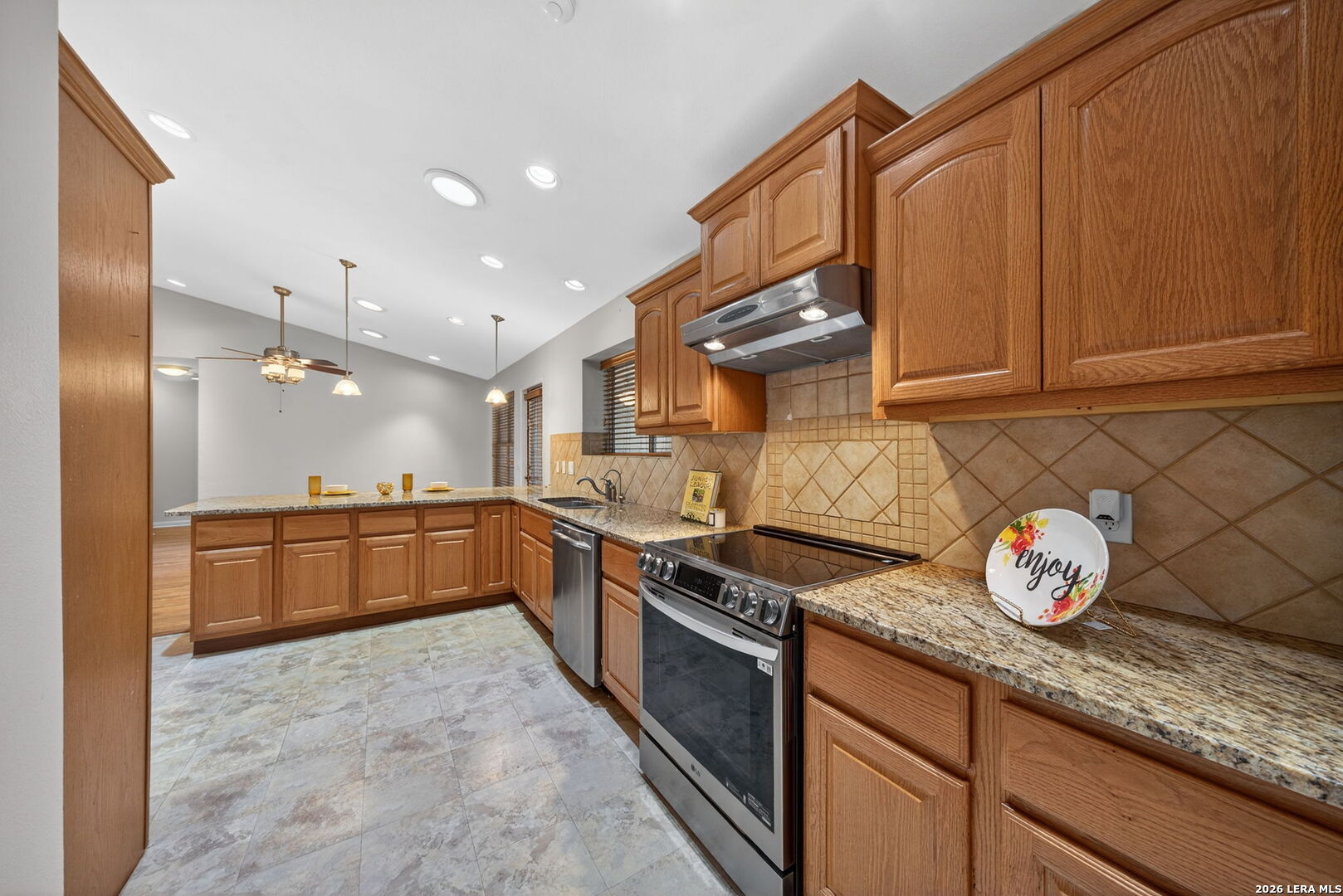 121 Fort Wayne Universal City, TX 78148 - Photo 16 of 34 a kitchen with granite countertop a sink and a stove top oven