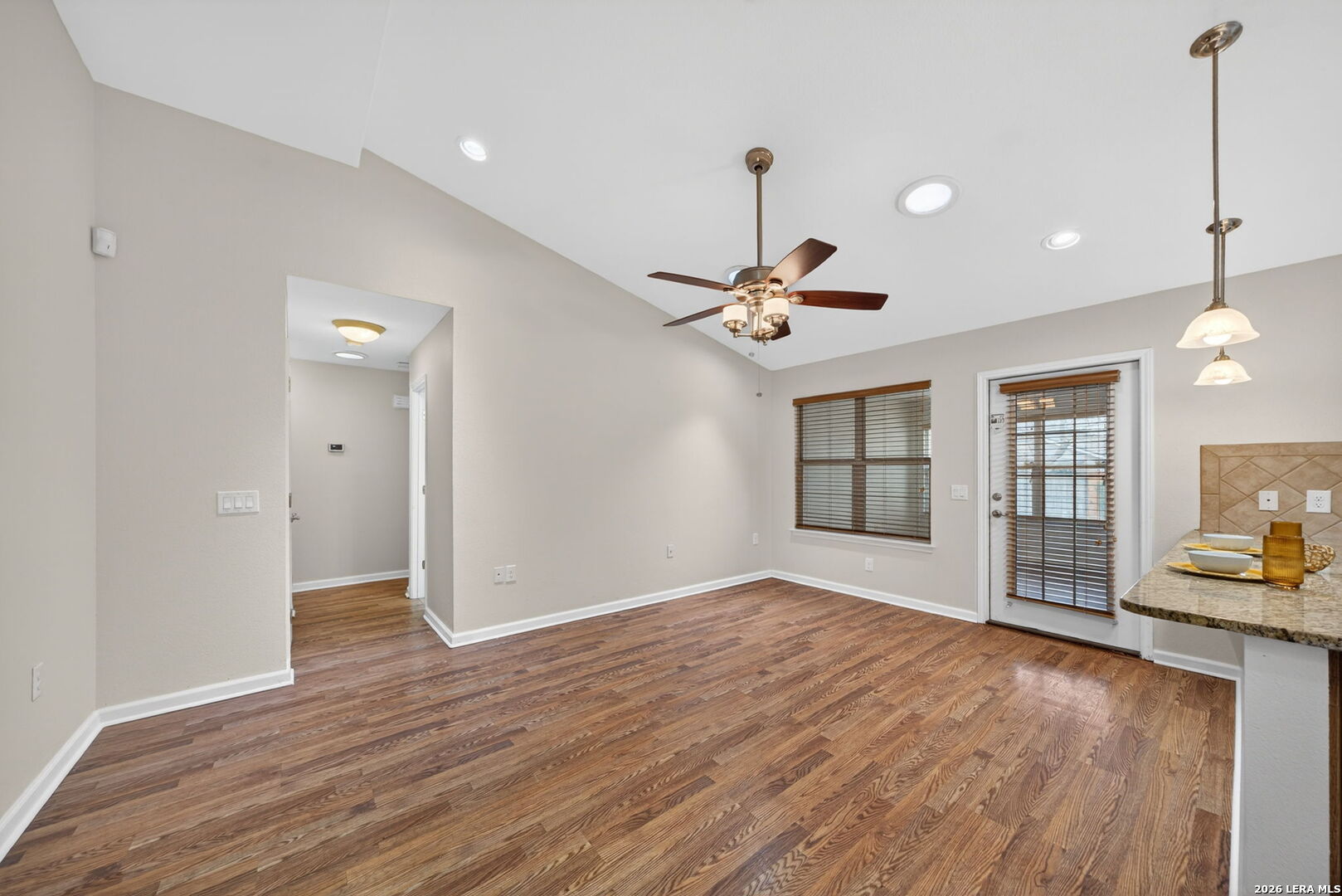 121 Fort Wayne Universal City, TX 78148 - Photo 10 of 34 a view of an empty room with window and wooden floor