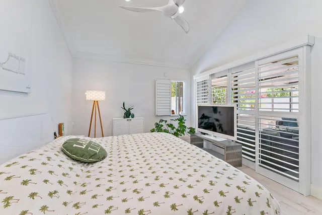 a spacious bathroom with a granite countertop sink a toilet a mirror and shower