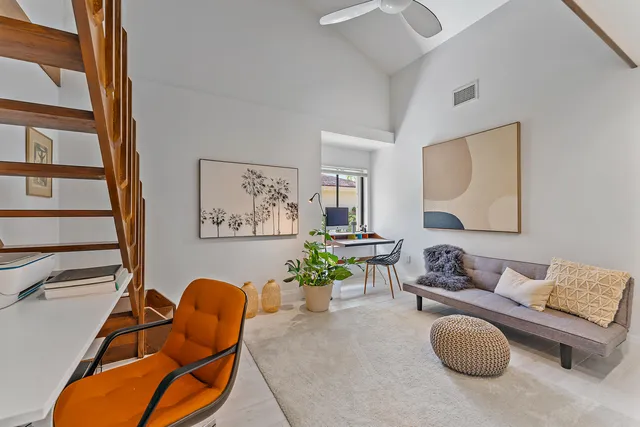 a living room with furniture and a potted plant