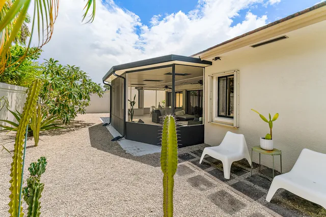 a view of a house with a large window and a yard