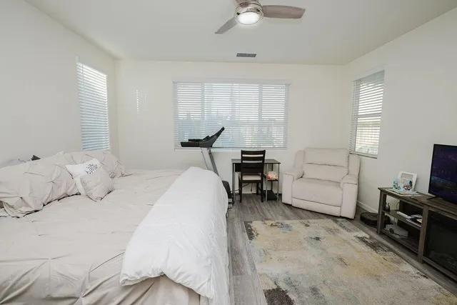 a bathroom with a sink a toilet a mirror and shower