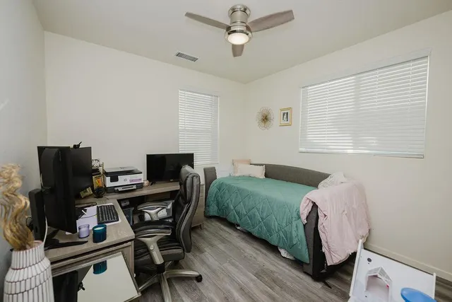 a living room with furniture a ceiling fan and a rug