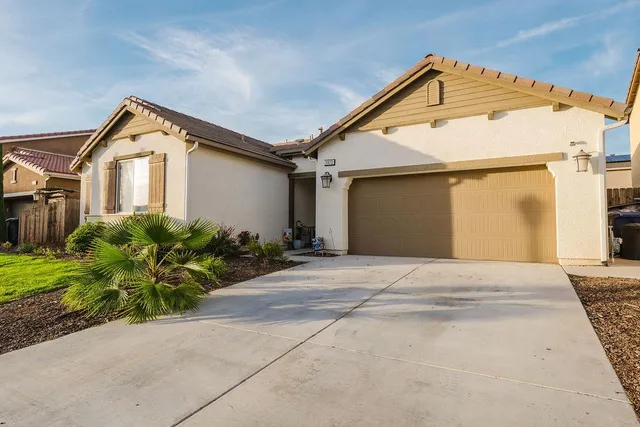 an aerial view of multiple houses with a yard