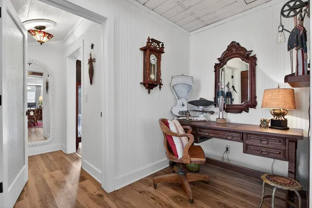 a view of hall way with furniture and mirror