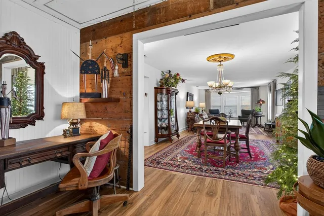 a view of a dining room with furniture and wooden floor
