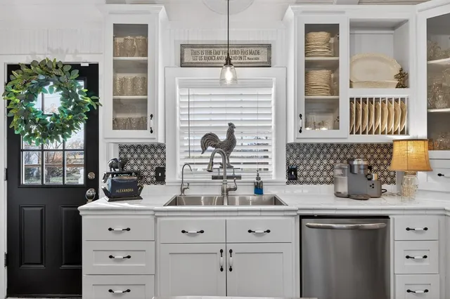 a kitchen with stainless steel appliances granite countertop a stove a sink dishwasher and cabinets with wooden floor