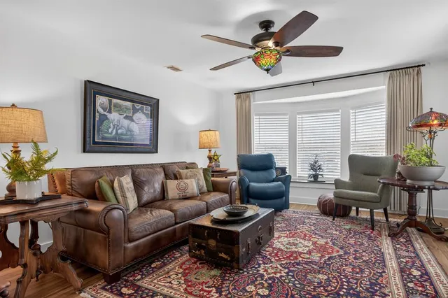 a living room with furniture a chandelier and a window