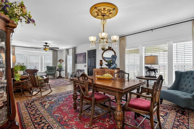 a living room with furniture a chandelier and a table