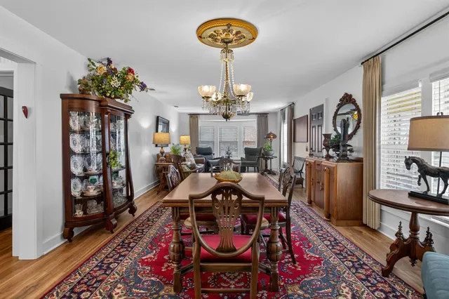 a view of a dining room with furniture and chandelier