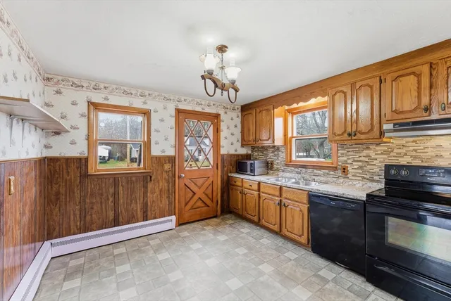 a kitchen with stainless steel appliances granite countertop a stove sink and cabinets