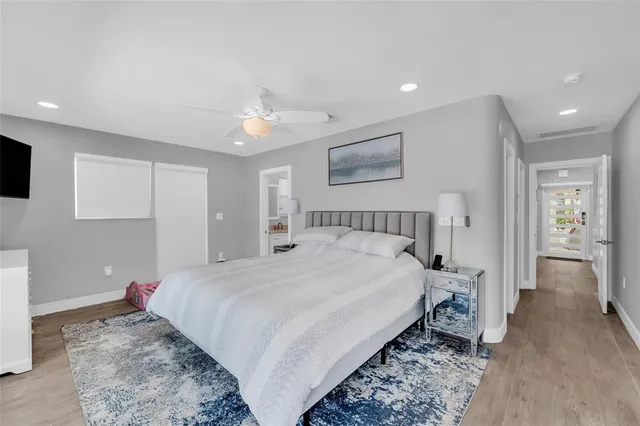 a bedroom with a large bed and a chandelier