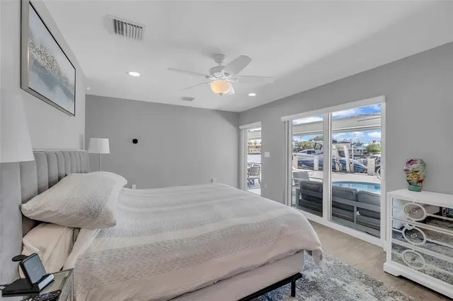 a bedroom with a bed and a bookshelf with wooden floor