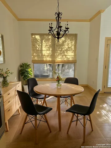 a spacious bedroom with a large bed and a chandelier