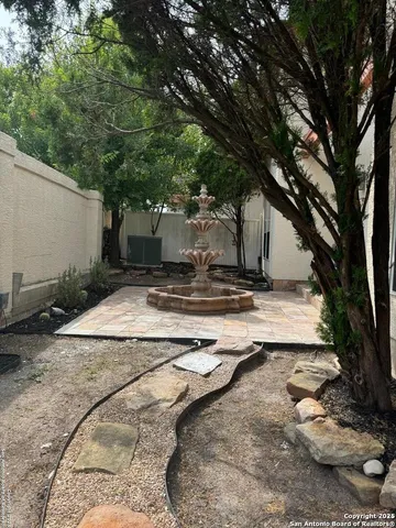 a backyard of a house with table and chairs