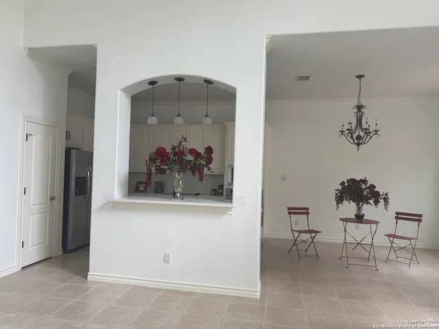 a view of a room with a table and chairs